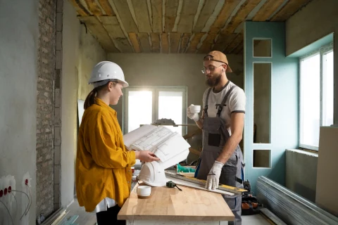 man and woman talking about a project